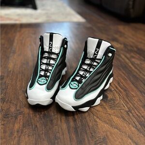 Stylish Black and White High-Top Sneakers with Teal Details